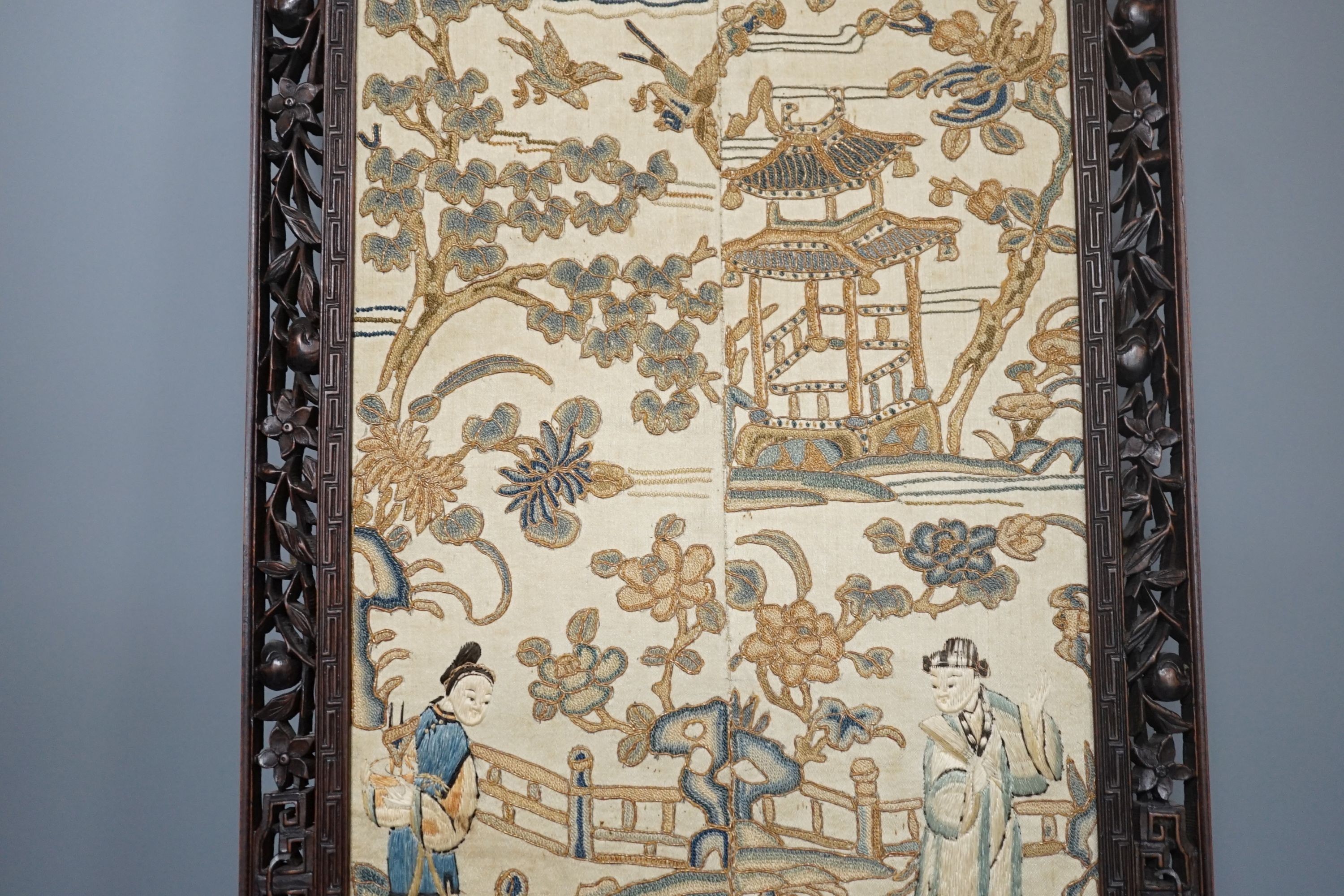 A pair of Chinese silk Beijing knot embroidered sleeve bands in a carved rosewood frame, 22 cms wide x 58.5 cms high, including frame.